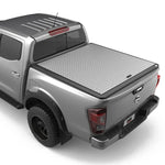Load image into Gallery viewer, A silver aluminium tonneau cover fitted on a Nissan Navara NP300 pickup truck.