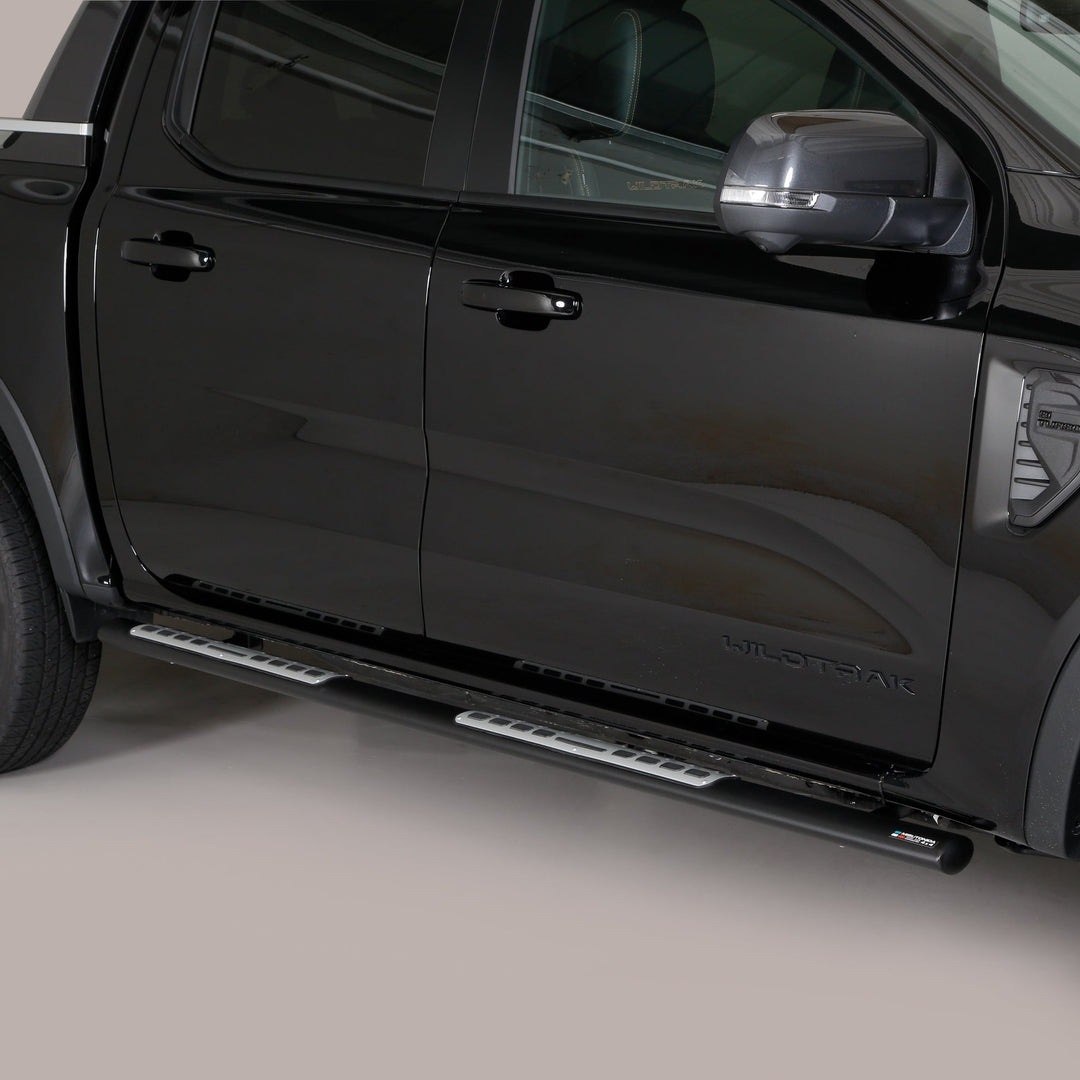A black pickup truck shown from a side-rear angle, featuring silver metal running boards mounted along the side of the vehicle.