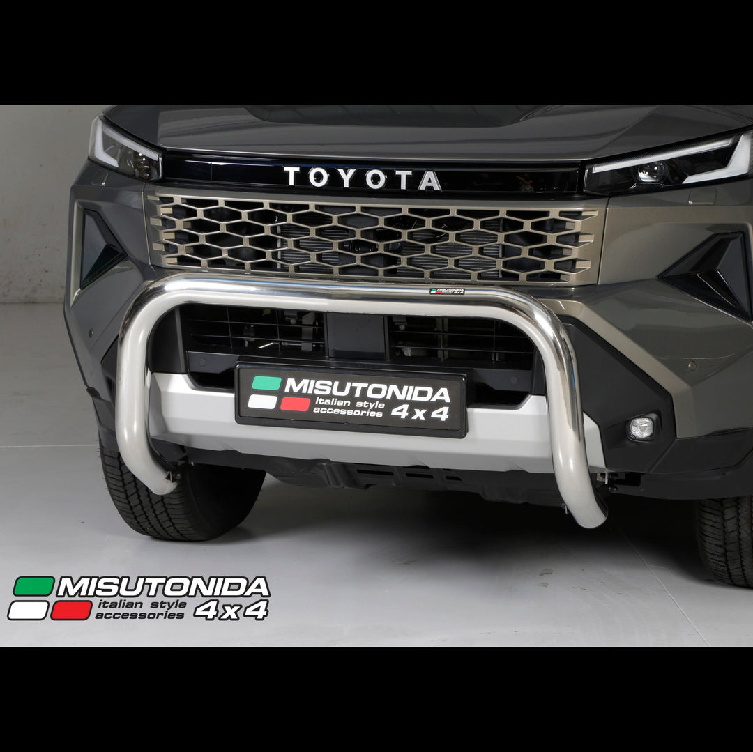 A Misutonida Italian Style 4x4 chrome bull bar front bumper guard installed on a dark gray Toyota Hilux Travo 4x4 vehicle, shown from the front in a studio setting.