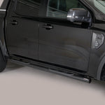 Load image into Gallery viewer, A black side step bar installed on the rear side of a black pickup truck, shown in a studio setting against a light gray background.