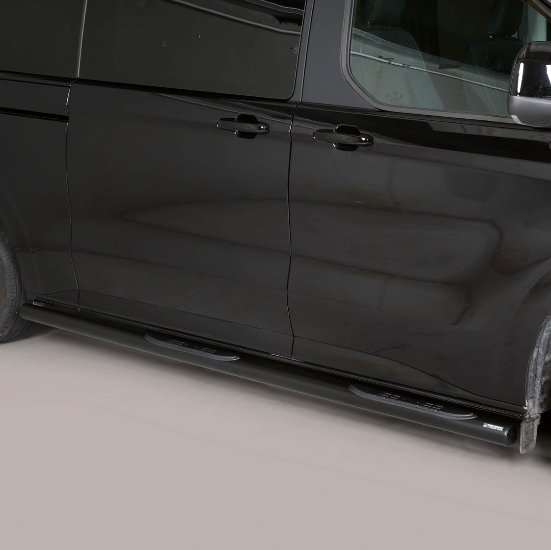 A black side view of a minivan with black running boards installed along the side, photographed against a neutral light gray studio background.