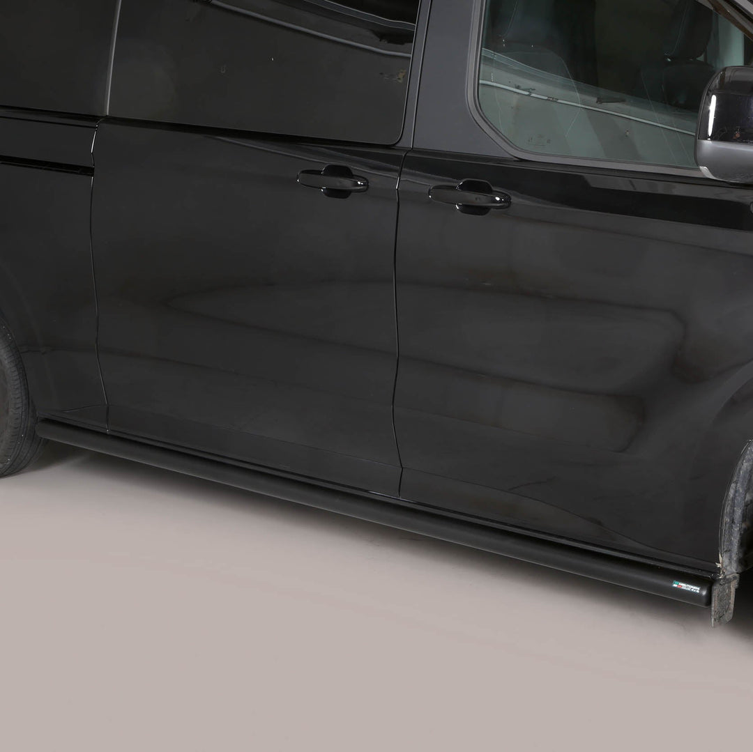 A black side view of a minivan with chrome wheels and a black side step bar installed along the lower side door.