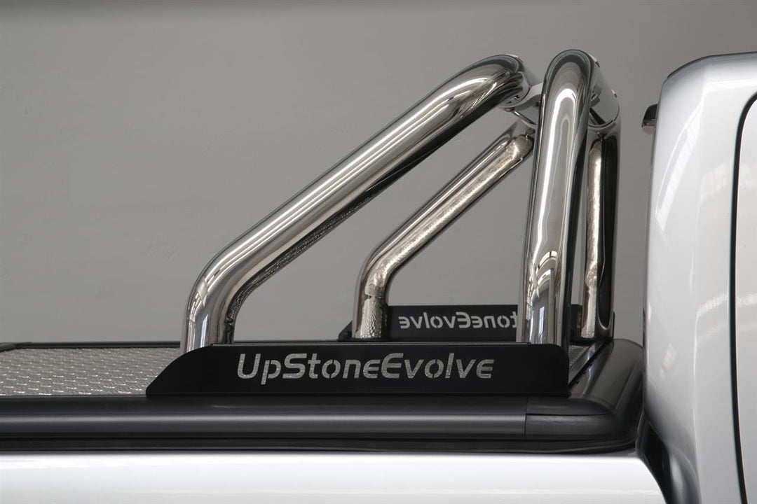 Chrome truck bed roll bar system with 'UpStoneEvolve' branding on a truck.