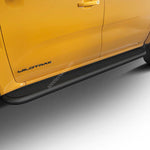 Load image into Gallery viewer, A close-up of a bright yellow Ford Wildtrak truck showing the side step protectors, door panel, and wheel area against a clean white studio background.