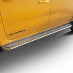 Load image into Gallery viewer, A close-up of a bright yellow Ford Wildtrak truck showing the side step protectors and running boards, with the 'WILDTRAK' badge visible on the rear door.