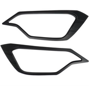 Two black car headlight covers for Isuzu D-Max 2025-on