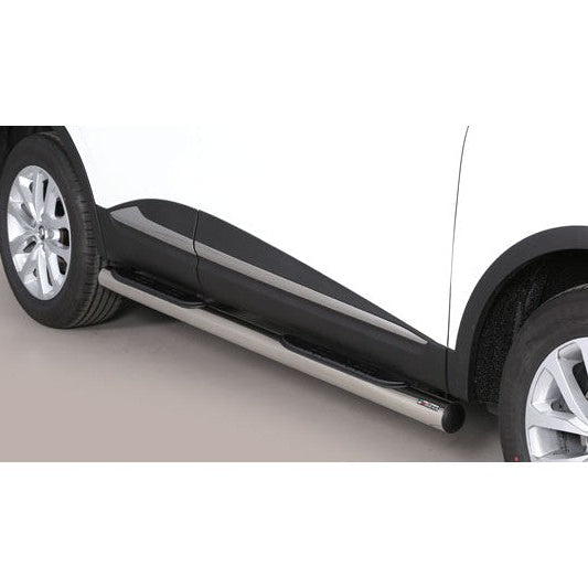 A close-up of a white vehicle side panel showing a black side step with a silver metal running bar, fitted over the wheel arch.