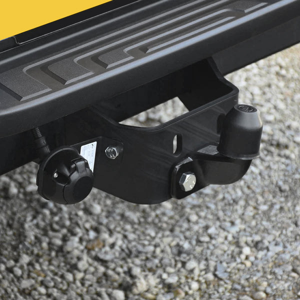 Close-up view of a pick up truck fixed flange tow bar attached to the rear of a vehicle.