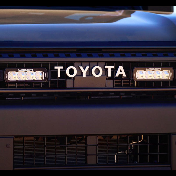Close-up of a Toyota vehicle with LED lights on a dark background