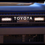 Close-up of a Toyota vehicle with LED lights on a dark background