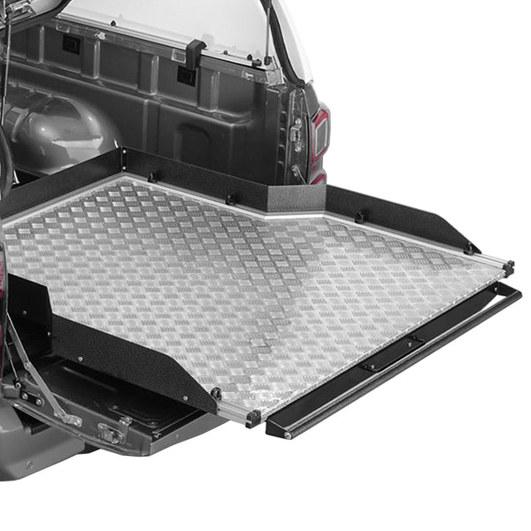 A wide chequer plate bed slide for pickup truck, featuring a black metal frame with a slip-resistant chequer plate surface, installed in the truck bed.